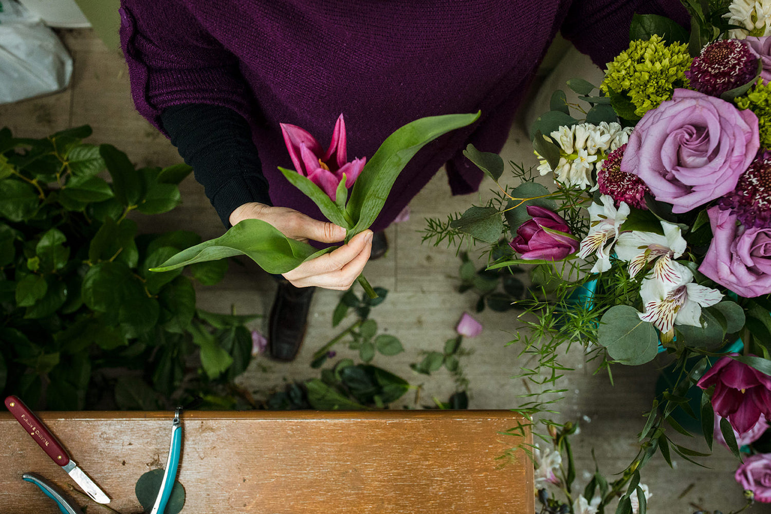 Green, white, and purple fresh cut flowers.