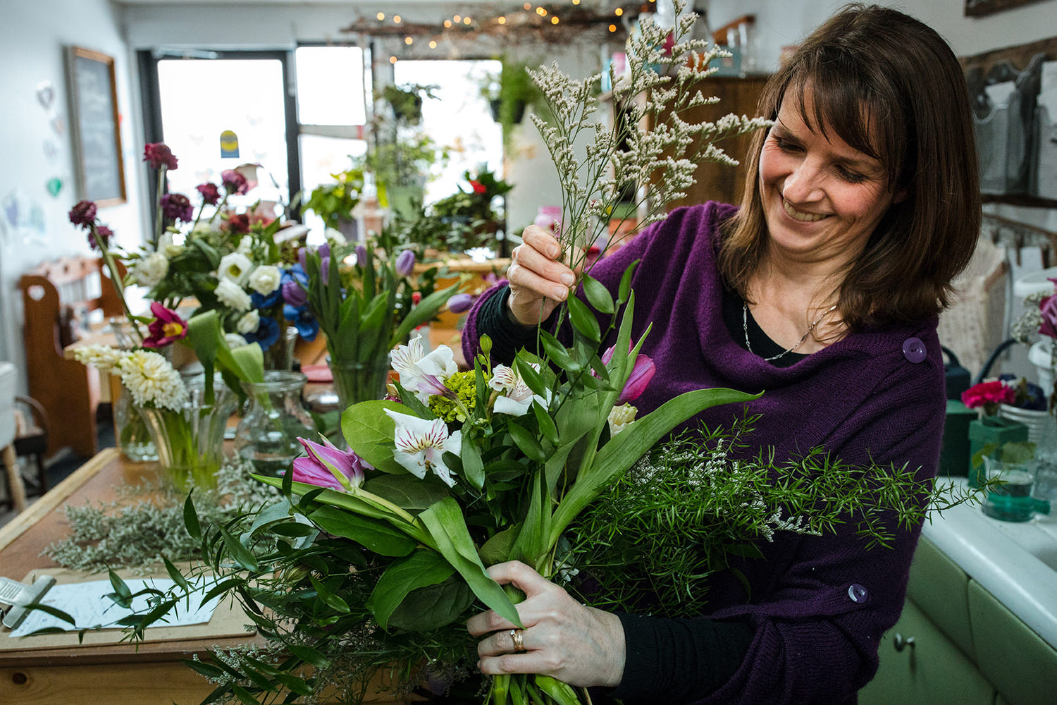 Local Ontario flower shop. Fresh bouquet made with green, white, and purple flowers.