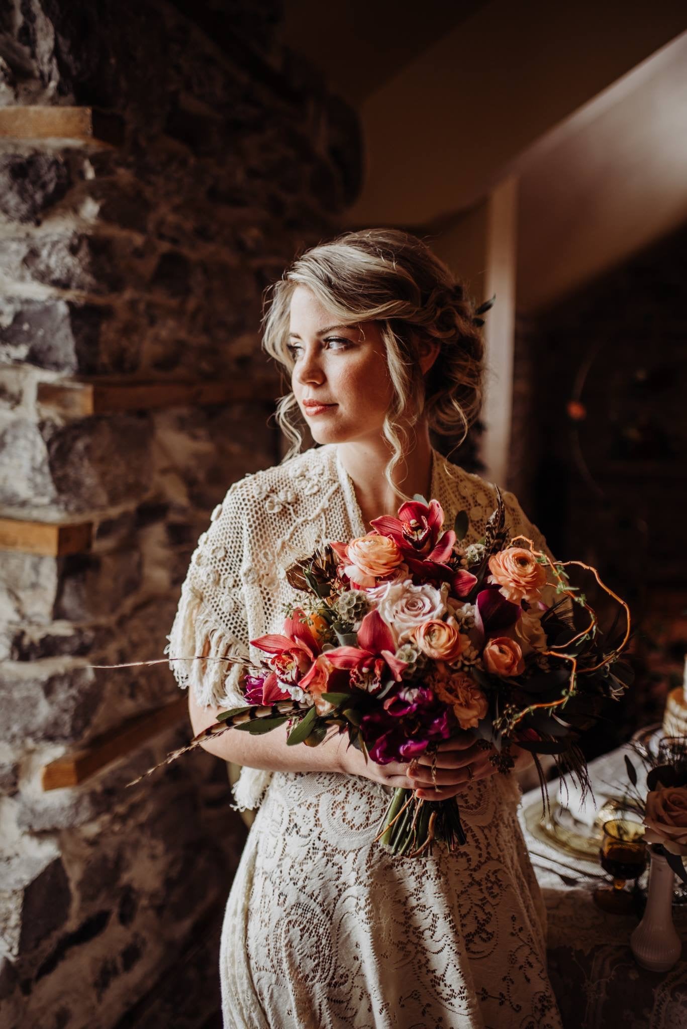 Pink and orange bridal bouquet. Bride holding large flower bouquet made of pink and orange flowers.